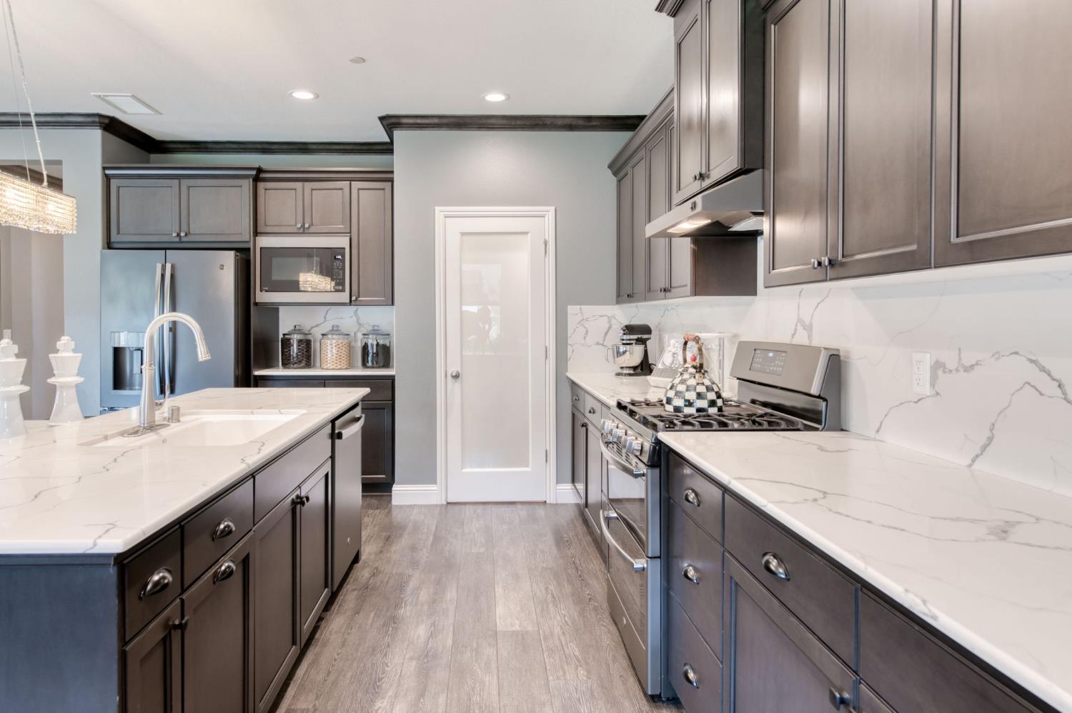 273 Meridian Avenue Madera, CA 93636 - Photo 36 of 55 a kitchen with stainless steel appliances granite countertop a sink stove and refrigerator