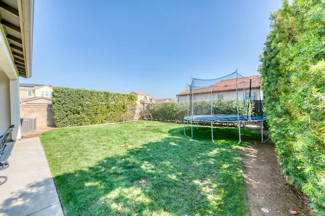 a aerial view of a house with a yard and potted plants