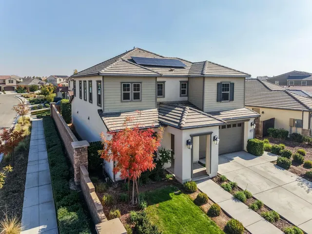 an aerial view of a residential houses with outdoor space