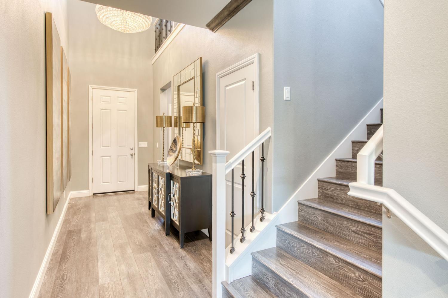 273 Meridian Avenue Madera, CA 93636 - Photo 6 of 55 a view of a hallway with wooden floor and staircase
