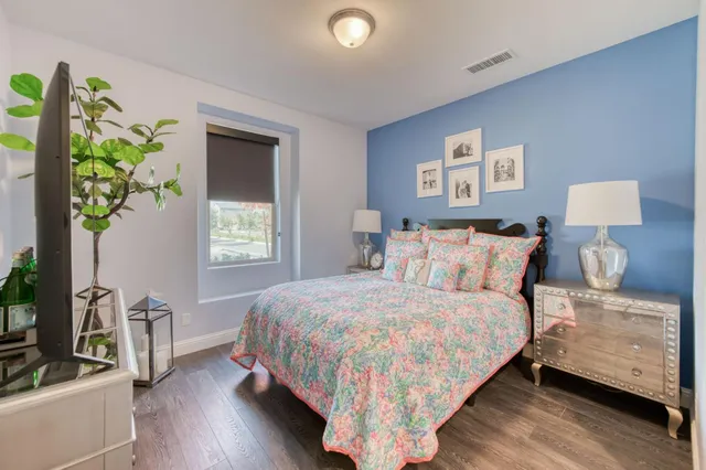 a bedroom with a bed and a potted plant