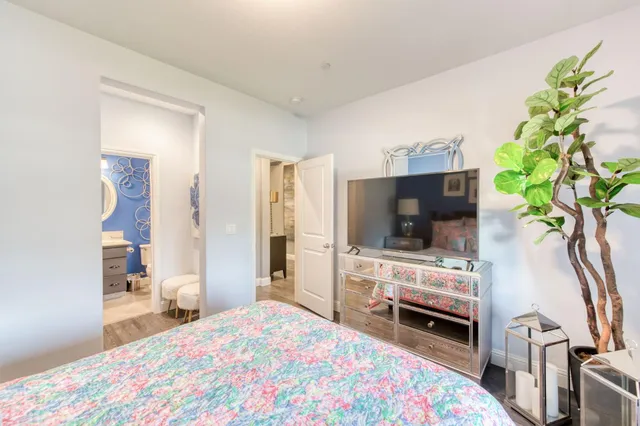 a bedroom with a bed and flat screen tv