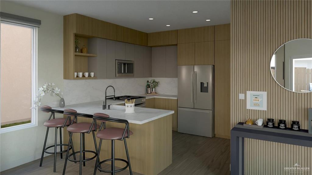 2905 Santa Amanda, Unit 2 Weslaco, TX 78596 - Photo 2 of 11 a kitchen with a table and chairs in it