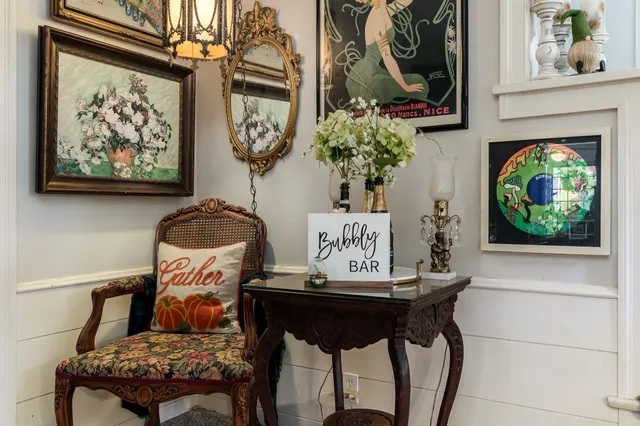 a living room with furniture and flowers