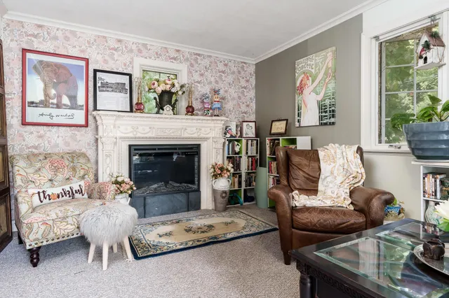 a living room with furniture and a fireplace