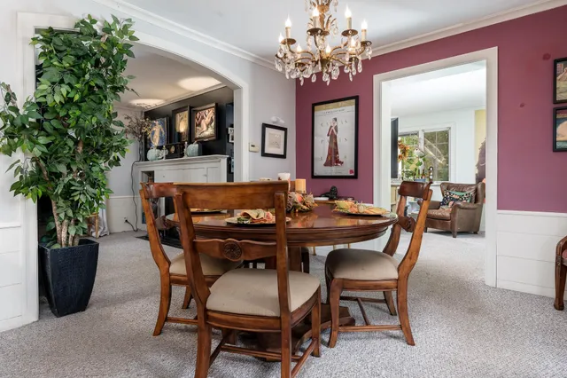 a view of a dining room with furniture and a potted plant