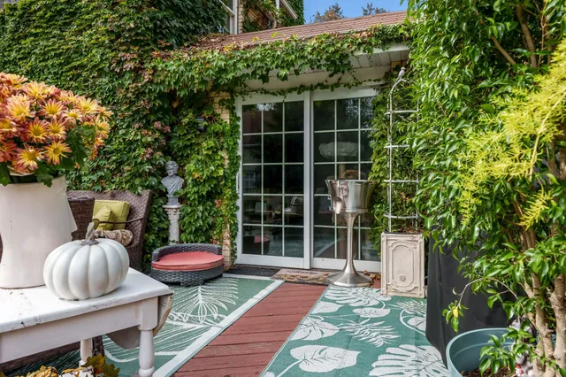 a view of a chairs and table in backyard