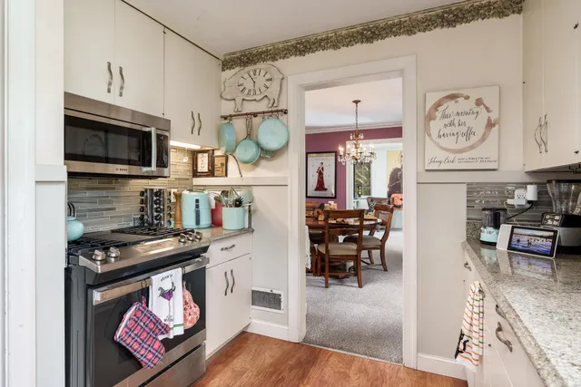 a kitchen with stainless steel appliances granite countertop a stove and cabinets