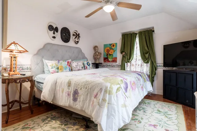 a bed sitting in a bedroom and a flat tv screen