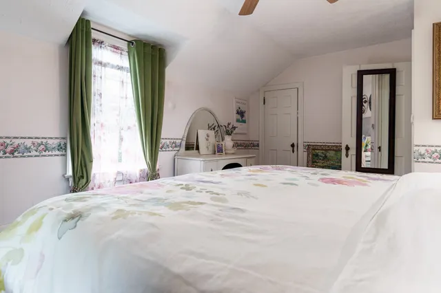 a bedroom with a bed and a large mirror