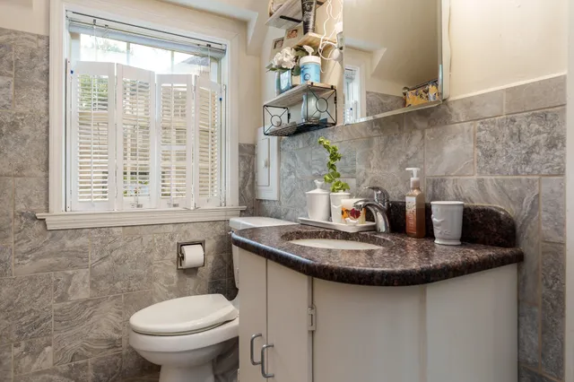 a bathroom with a toilet sink and mirror
