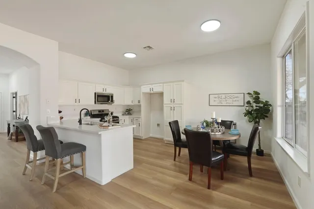 a view of a dining room with furniture and a kitchen