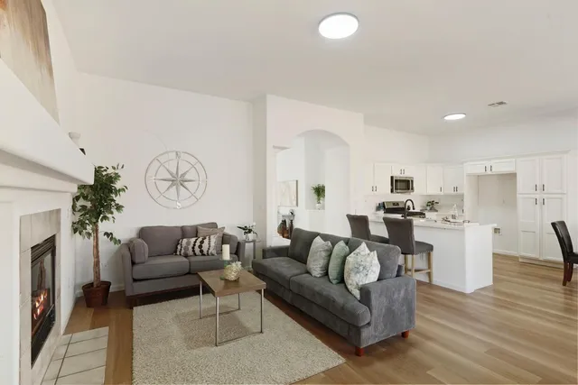 a living room with furniture and a wooden floor