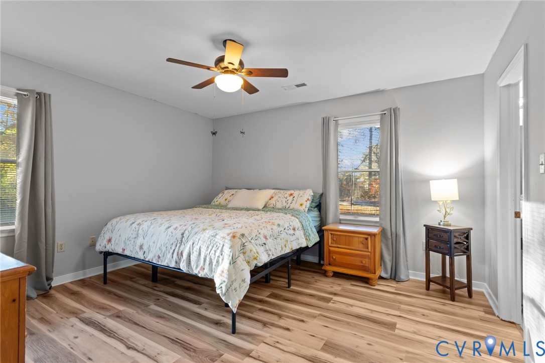 37 La Mae Court Aylett, VA 23009 - Photo 14 of 36 a bedroom with a bed and a chandelier