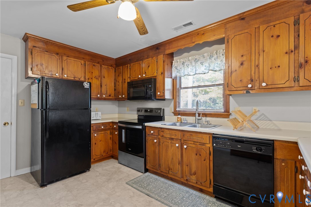 37 La Mae Court Aylett, VA 23009 - Photo 4 of 36 a kitchen with stainless steel appliances granite countertop a refrigerator a sink dishwasher a stove with wooden cabinets and floor