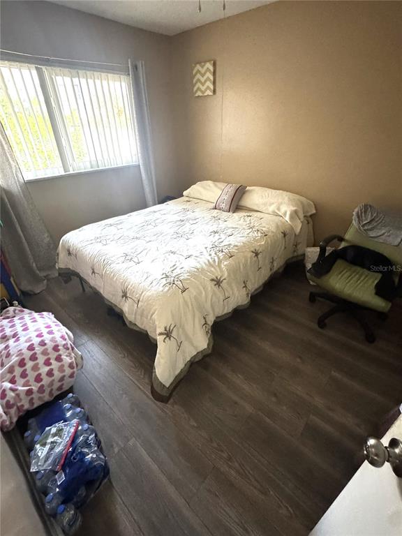 1702 Hickorywood Lane Orlando, FL 32818 - Photo 7 of 8 a bedroom with bed and window