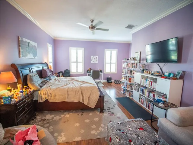 a bedroom with a bed furniture and a flat screen tv