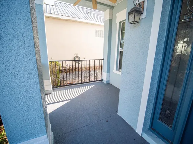 a view of a small space with wooden floor and windows