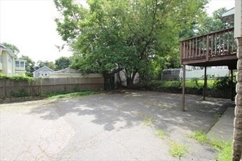 43 Chapman Street, Unit 2 Watertown, MA 02472 - Photo 12 of 12 a view of a wooden house with a yard