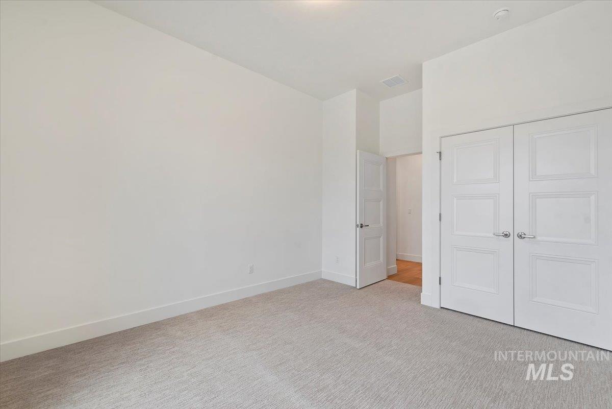 1297 Chena Street Middleton, ID 83644 - Photo 24 of 38 Unfurnished bedroom with light carpet and a closet