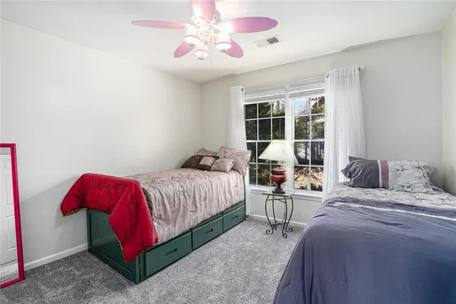 a view of a room with furniture and wall paintings