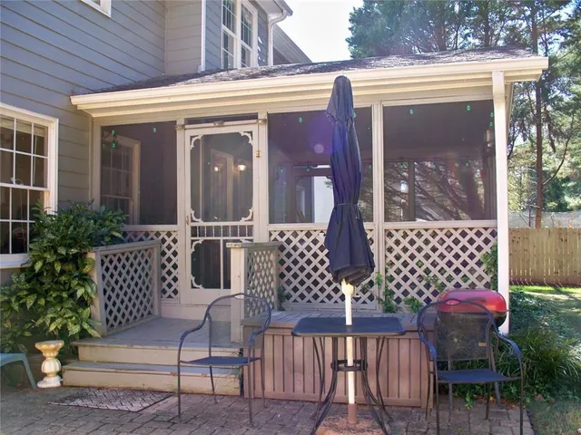 a kitchen with a table chairs stove and cabinets