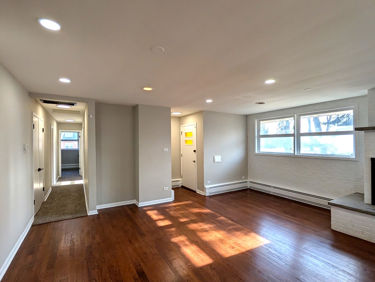 14844 Dearborn Street Dolton, IL 60419 - Photo 4 of 15 an empty room with wooden floor and windows