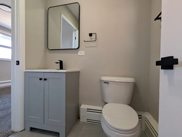 a white toilet sitting next to a bathroom sink