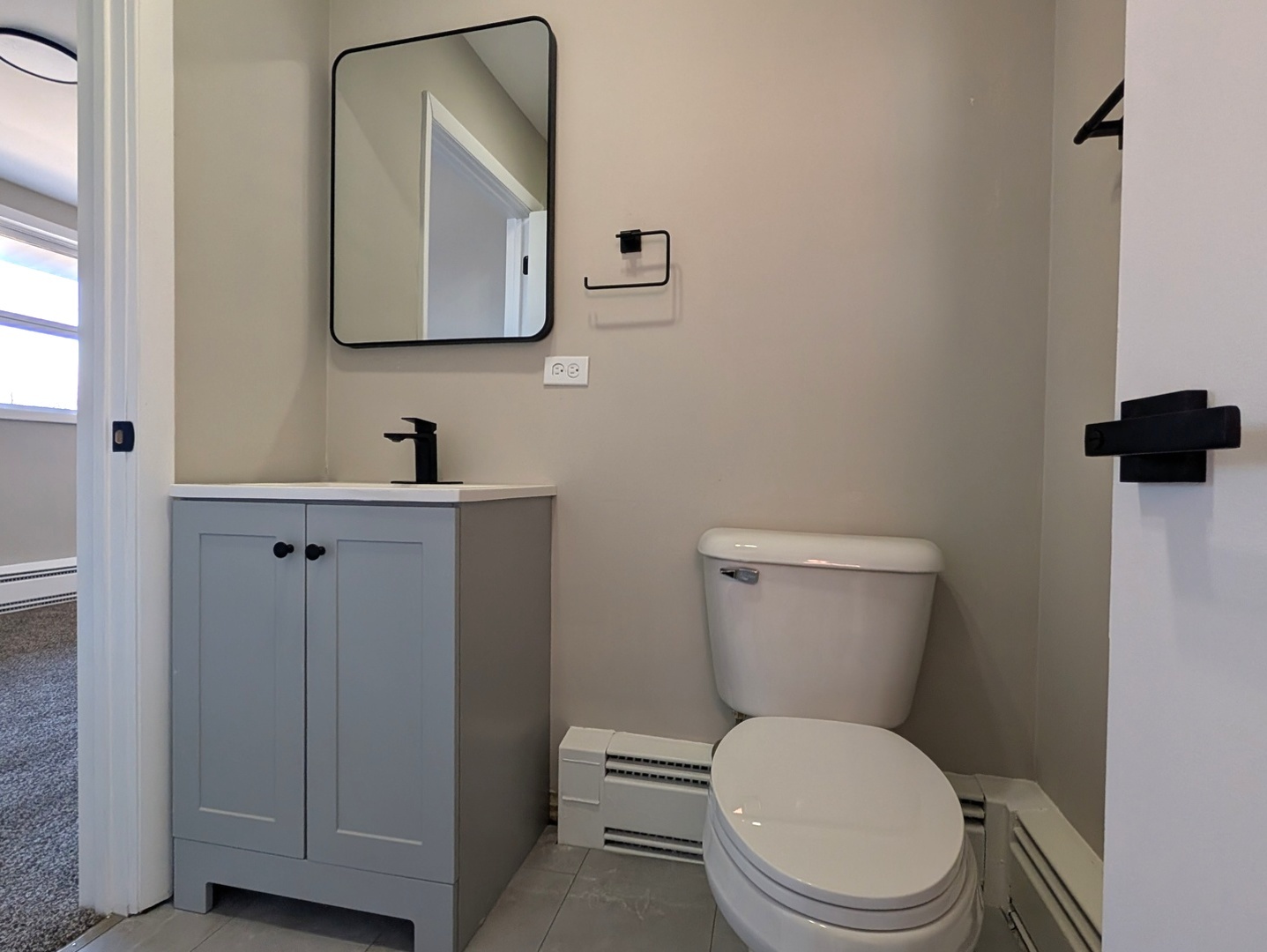 14844 Dearborn Street Dolton, IL 60419 - Photo 8 of 15 a white toilet sitting next to a bathroom sink