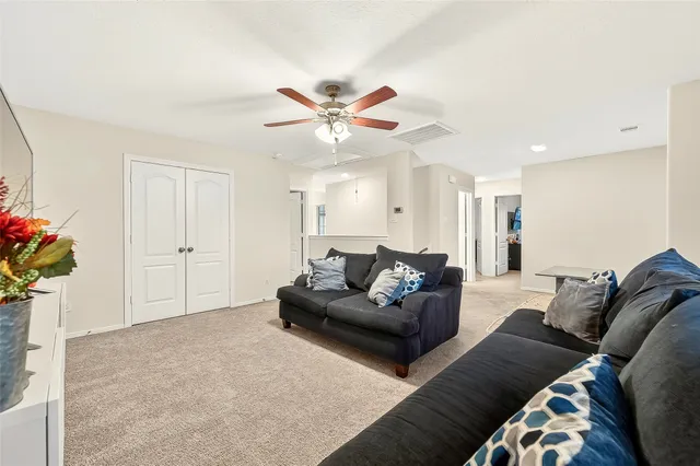 a living room with furniture and flowers