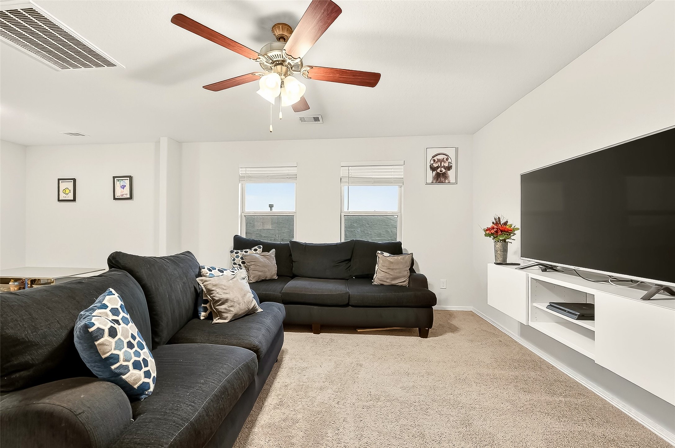 10023 Yanet Grove Lane Houston, TX 77044 - Photo 12 of 40 a living room with furniture and a flat screen tv
