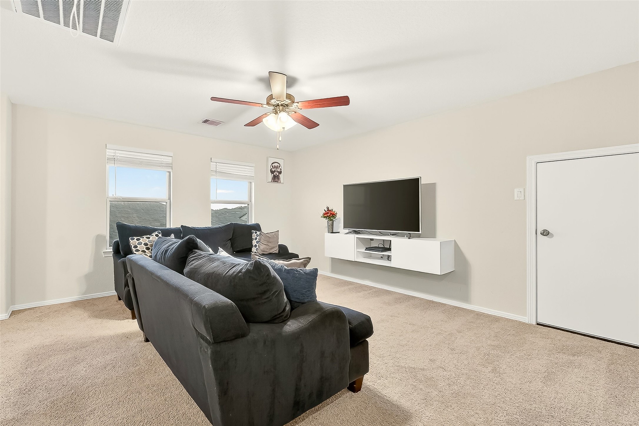 10023 Yanet Grove Lane Houston, TX 77044 - Photo 14 of 40 a living room with furniture and a flat screen tv