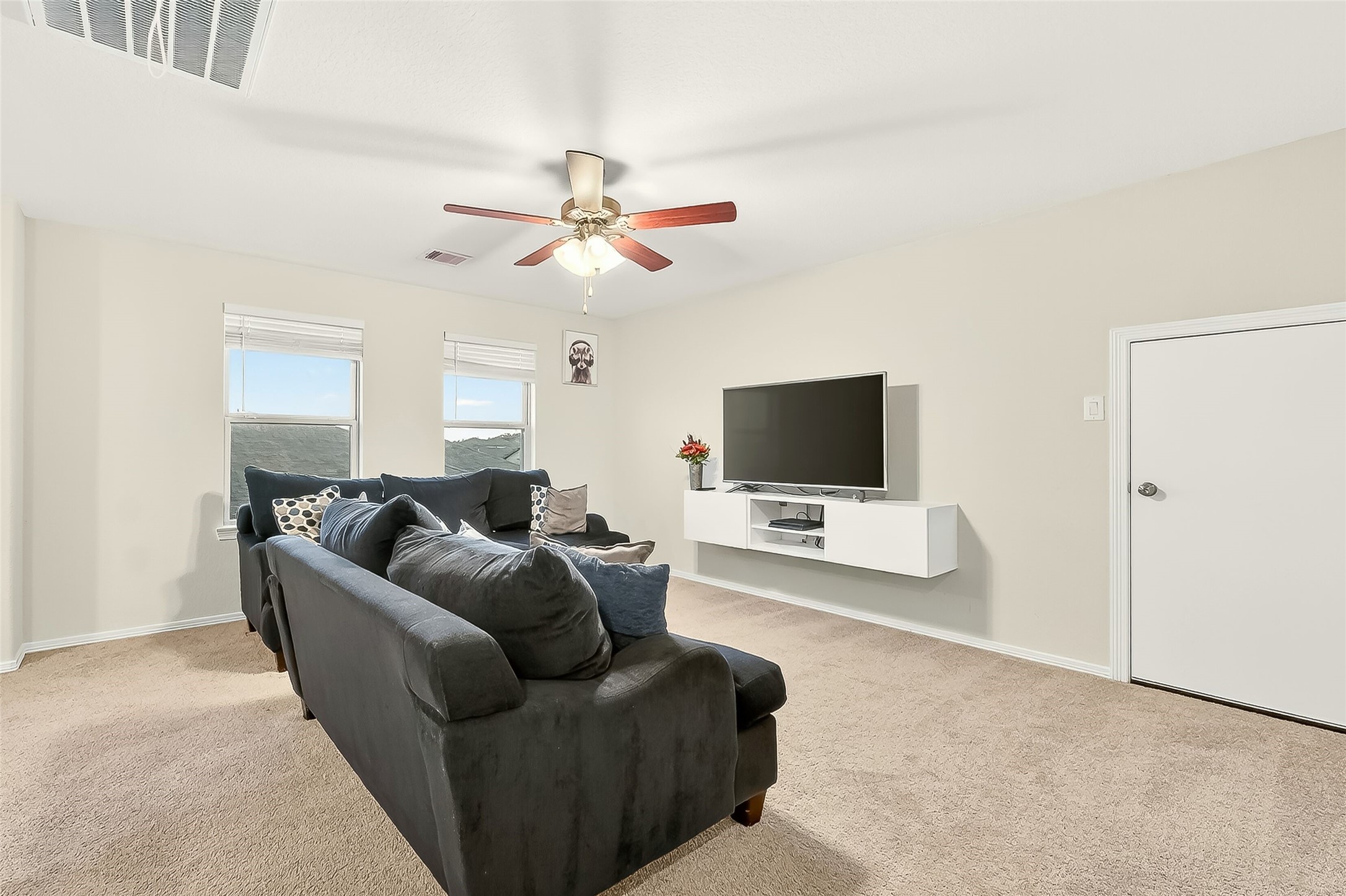 10023 Yanet Grove Lane Houston, TX 77044 - Photo 15 of 40 a living room with furniture and a flat screen tv