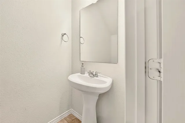 a bathroom with a sink a mirror and a shower