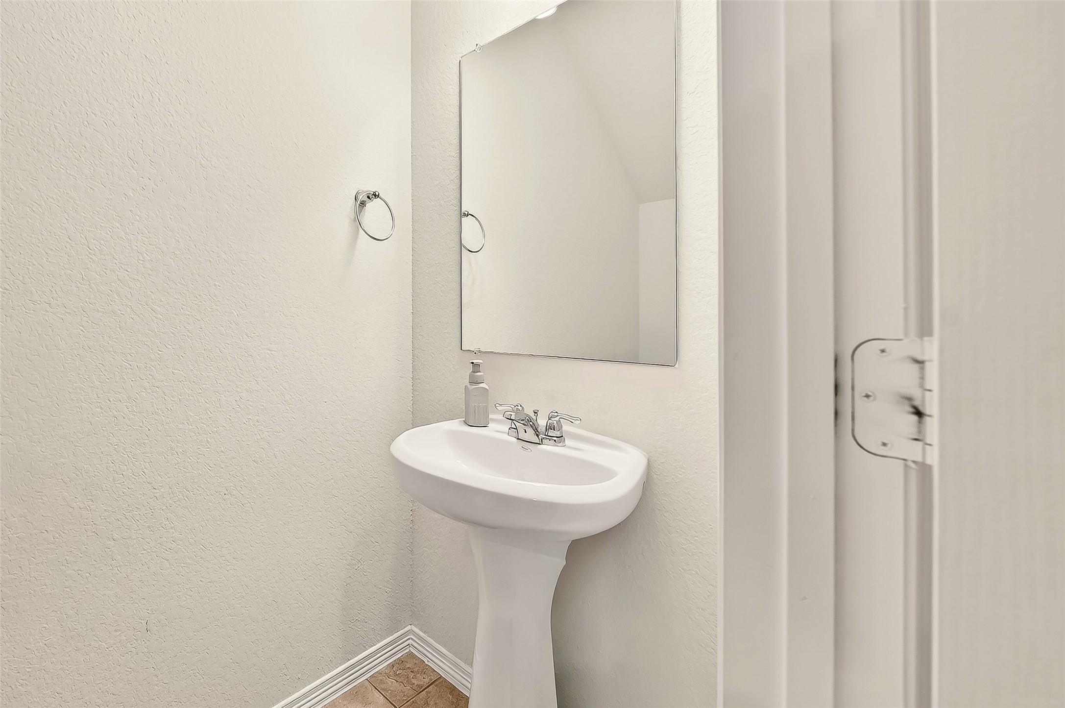 10023 Yanet Grove Lane Houston, TX 77044 - Photo 17 of 40 a bathroom with a sink a mirror and a shower