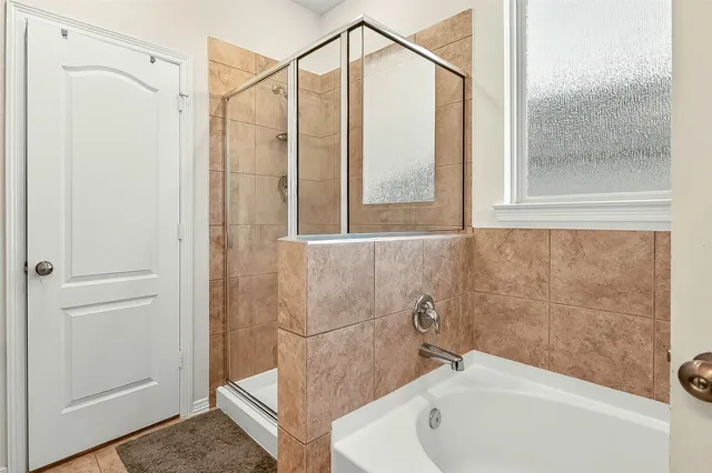 a bathroom with a bathtub and a shower