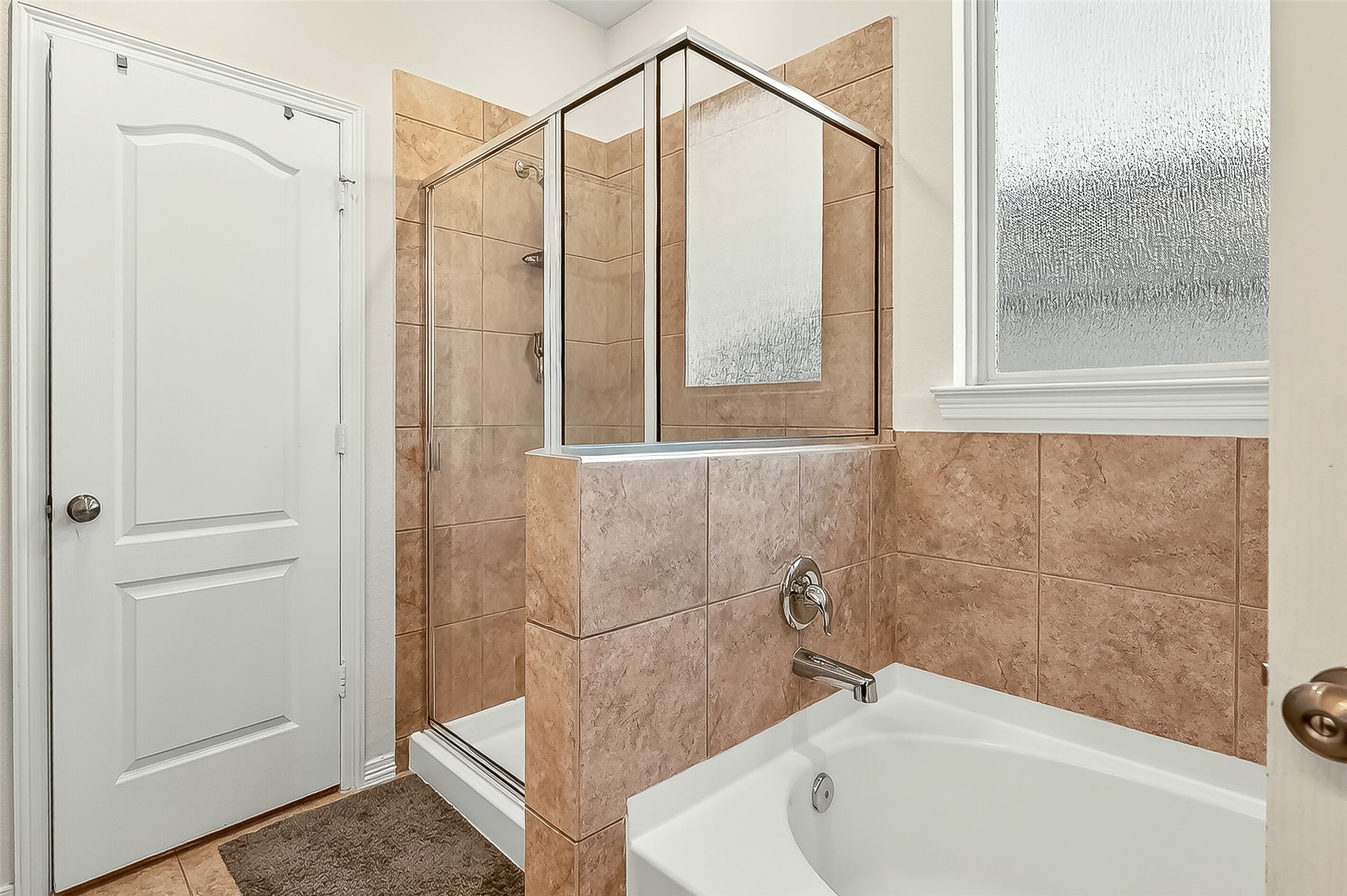 10023 Yanet Grove Lane Houston, TX 77044 - Photo 21 of 40 a bathroom with a bathtub and a shower