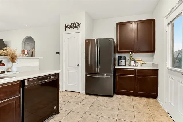 a kitchen with granite countertop a refrigerator and a sink
