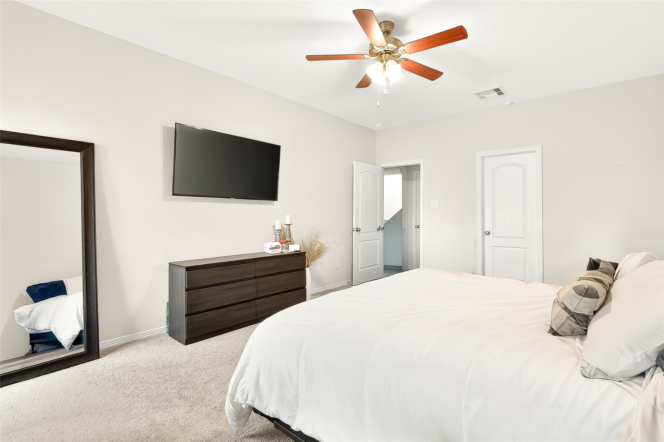 10023 Yanet Grove Lane Houston, TX 77044 - Photo 23 of 40 a bedroom with a bed and a flat screen tv