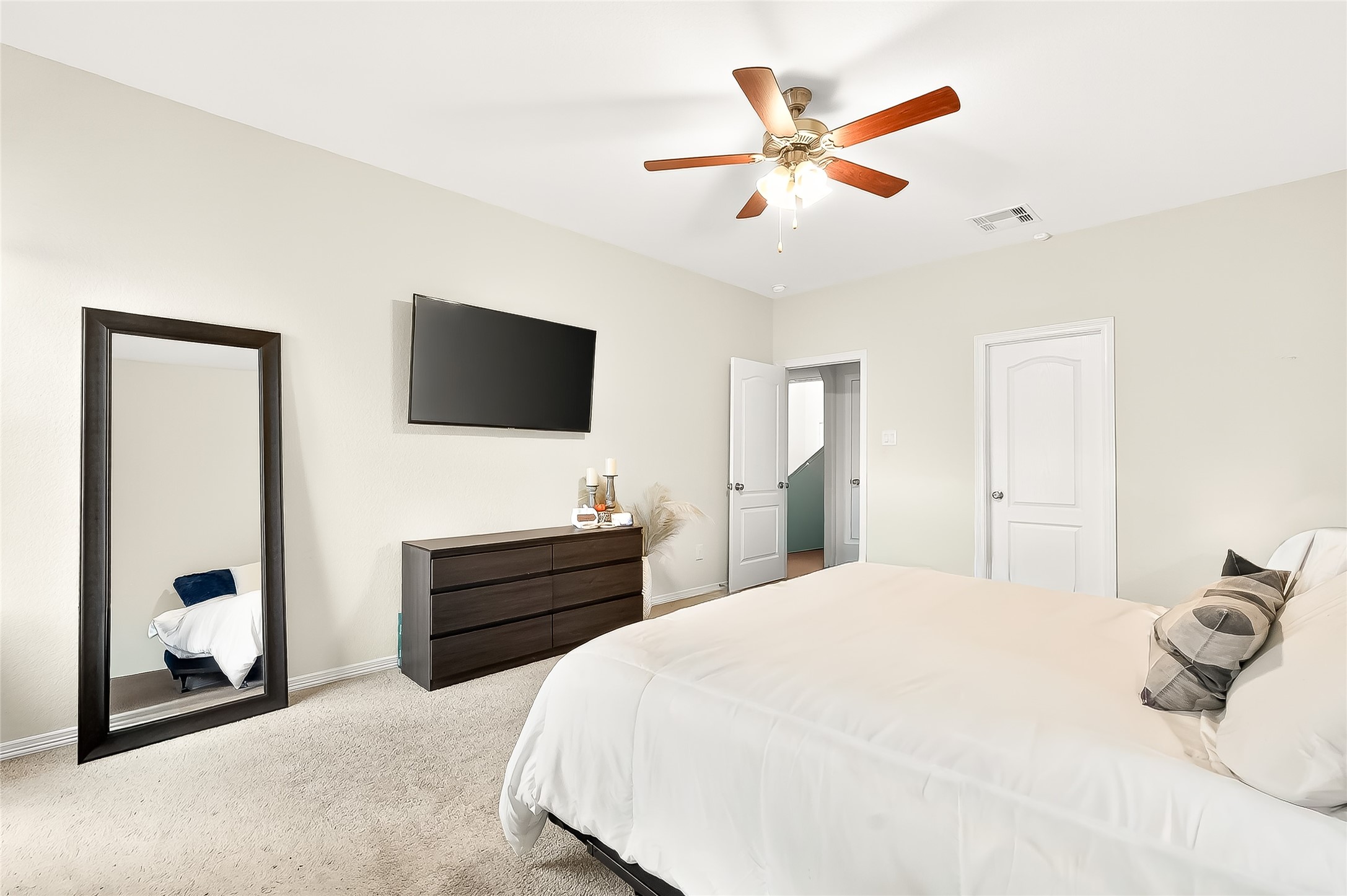 10023 Yanet Grove Lane Houston, TX 77044 - Photo 24 of 40 a bedroom with a bed and a flat screen tv