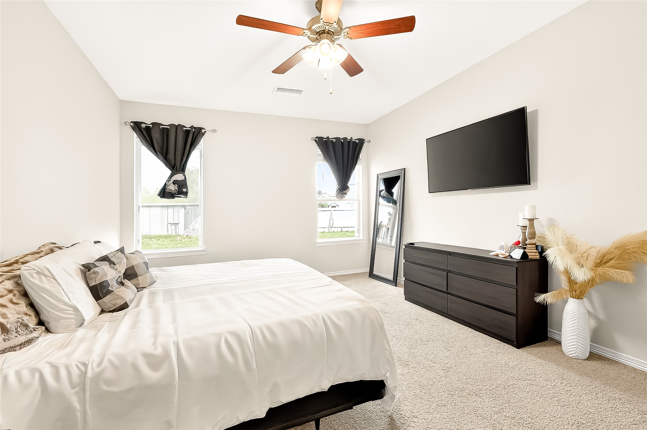 10023 Yanet Grove Lane Houston, TX 77044 - Photo 27 of 40 a bedroom with a bed and a flat screen tv