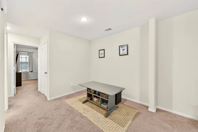 a living room with a bed furniture and a window
