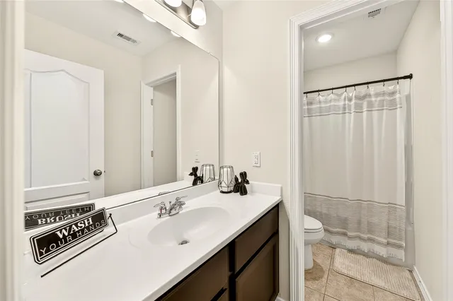a bathroom with a double vanity sink a mirror and a shower