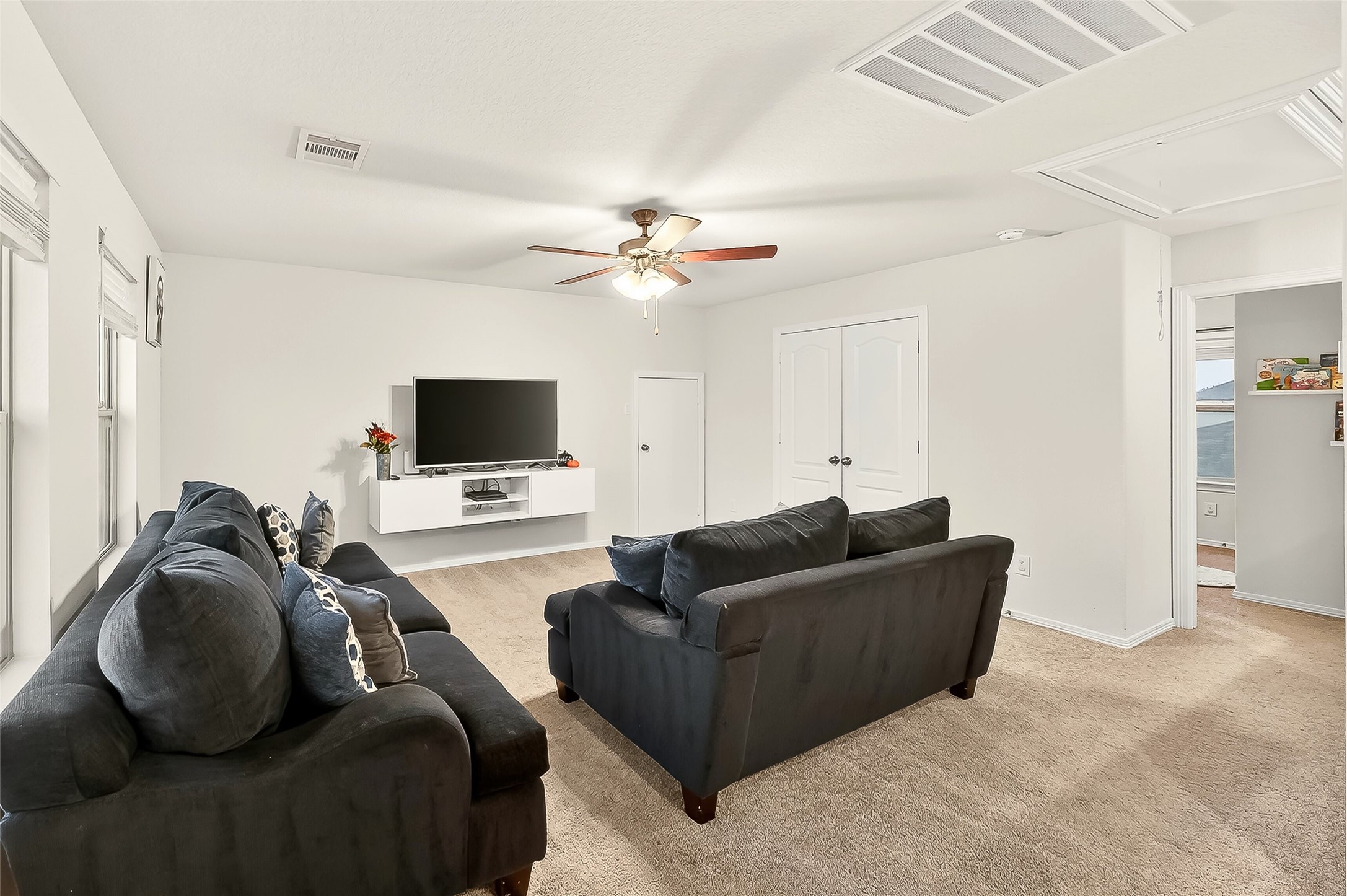 10023 Yanet Grove Lane Houston, TX 77044 - Photo 35 of 40 a living room with furniture and a flat screen tv