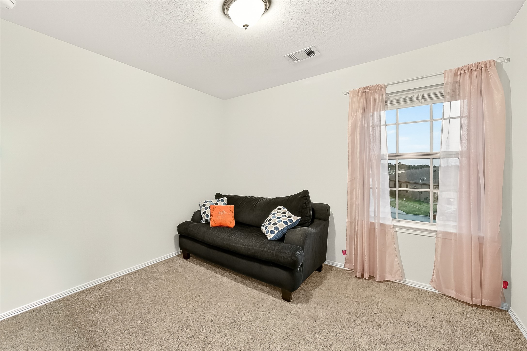 10023 Yanet Grove Lane Houston, TX 77044 - Photo 36 of 40 a living room with furniture and a window