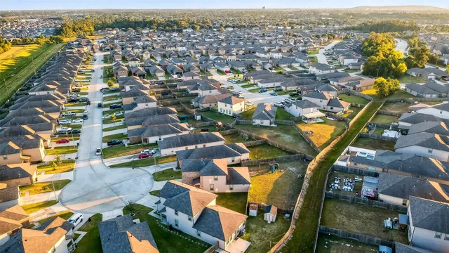 an aerial view of residential houses with outdoor space