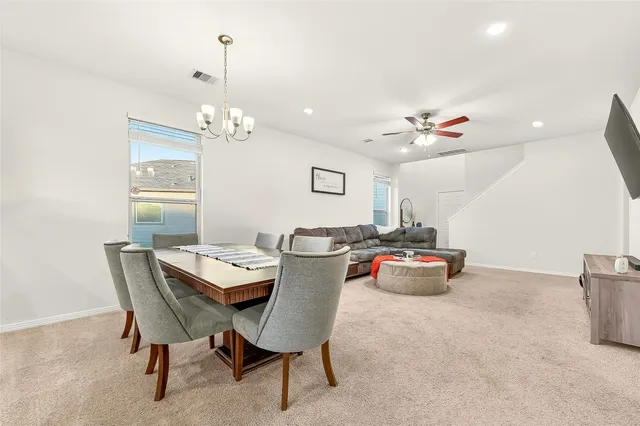a dining room with furniture and window