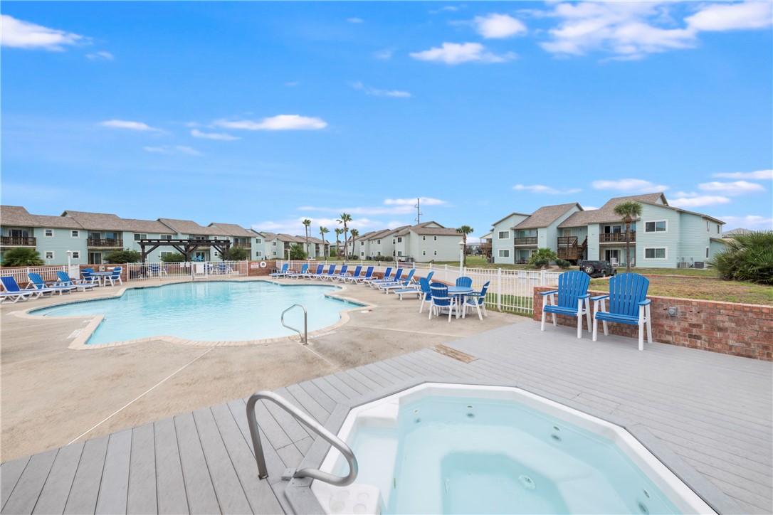 230 Cut-Off Road, Unit 101 Port Aransas, TX 78373 - Photo 28 of 30 a view of swimming pool with outdoor seating and city view