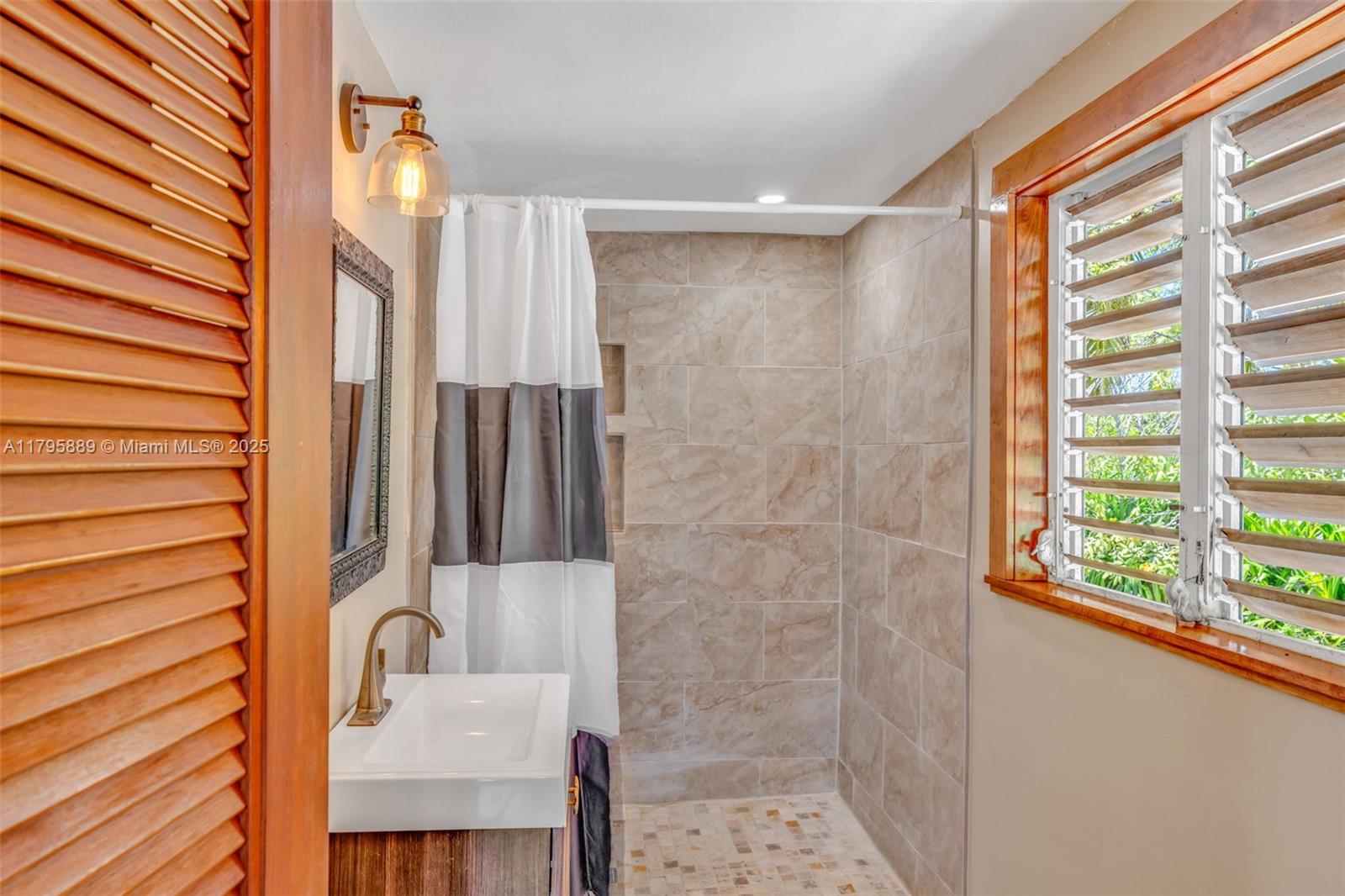 Lower Keys Big Pine Key, FL 33043 - Photo 12 of 43 a bathroom with a sink a mirror and a shower