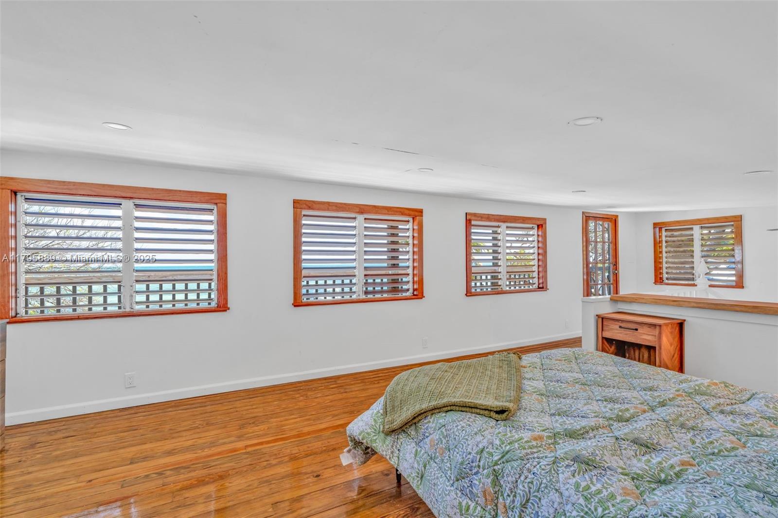 Lower Keys Big Pine Key, FL 33043 - Photo 17 of 43 a bedroom with a bed and wooden floor